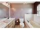 Bathroom with a bathtub, toilet, and double vanity at 31226 Saint Joe Rd, Dade City, FL 33525