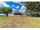 Ranch-style home exterior with a screened porch and large yard at 31226 Saint Joe Rd, Dade City, FL 33525