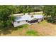 Aerial view of a ranch-style home with a large yard and tractor at 31226 Saint Joe Rd, Dade City, FL 33525