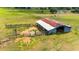 Aged barn with rusty metal roof and corral at 31226 Saint Joe Rd, Dade City, FL 33525