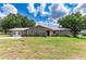 Stone ranch house with metal roof and large yard at 31226 Saint Joe Rd, Dade City, FL 33525