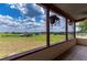 Screened porch with view of pasture and barn at 31226 Saint Joe Rd, Dade City, FL 33525