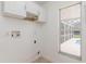 Laundry room with cabinets and view of backyard pool at 1553 Scotch Pine Dr, Brandon, FL 33511