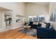Open living room with hardwood floors, large windows, and view of kitchen at 1553 Scotch Pine Dr, Brandon, FL 33511