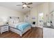 Bright bedroom with wood floors, ceiling fan and ensuite bathroom access at 1553 Scotch Pine Dr, Brandon, FL 33511