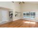 Open living room with vaulted ceiling, hardwood floors, kitchen view, and pool view at 1553 Scotch Pine Dr, Brandon, FL 33511
