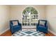 Cozy sitting area with two armchairs and a large arched window at 1553 Scotch Pine Dr, Brandon, FL 33511
