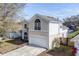Two-story house with beige siding, arched windows, and a two-car garage at 1553 Scotch Pine Dr, Brandon, FL 33511