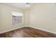 Well-lit bedroom featuring wood-look floors and a window with blinds at 1553 Scotch Pine Dr, Brandon, FL 33511