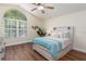 Main bedroom with wood flooring, large window, and a ceiling fan at 1553 Scotch Pine Dr, Brandon, FL 33511