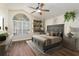 Spacious main bedroom with large window, hardwood floors, and a ceiling fan at 1553 Scotch Pine Dr, Brandon, FL 33511