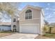 Two-story house with a large garage and well-maintained lawn at 1553 Scotch Pine Dr, Brandon, FL 33511