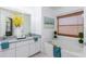 Bathroom boasts a relaxing bathtub and double vanity with granite top at 1553 Scotch Pine Dr, Brandon, FL 33511