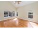 Living room with vaulted ceiling, hardwood floors, and pool view at 1553 Scotch Pine Dr, Brandon, FL 33511
