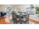 Bright dining room with hardwood floors, large window, and seating for six at 1553 Scotch Pine Dr, Brandon, FL 33511