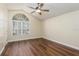 Spacious bedroom with hardwood floors and large arched window at 1553 Scotch Pine Dr, Brandon, FL 33511