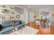 Open concept living and dining area with hardwood floors and a stylish sofa at 1553 Scotch Pine Dr, Brandon, FL 33511