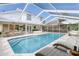Relaxing screened-in pool and patio area with lounge chairs at 1553 Scotch Pine Dr, Brandon, FL 33511