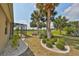 Landscaped backyard with palm trees and golf course view at 404 Grand Chateaux Way, Sun City Center, FL 33573