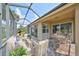 Screened patio with seating area and brick pavers at 404 Grand Chateaux Way, Sun City Center, FL 33573