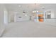 Spacious living room with an open concept design and neutral color palette at 404 Grand Chateaux Way, Sun City Center, FL 33573