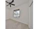 Bright bedroom with carpet flooring, large window, and ceiling fan at 404 Grand Chateaux Way, Sun City Center, FL 33573