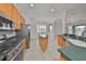 Kitchen with light wood cabinets, stainless steel appliances, and a large island at 404 Grand Chateaux Way, Sun City Center, FL 33573