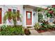 Front entrance with red door and lush landscaping at 11310 Stratton Park Dr # 1, Temple Terrace, FL 33617