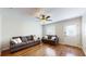 Bright living room with hardwood floors, ceiling fan, and comfy sofas at 11310 Stratton Park Dr # 1, Temple Terrace, FL 33617