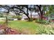 Landscaped backyard with lush green lawn and mature trees at 11310 Stratton Park Dr # 1, Temple Terrace, FL 33617