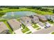 Aerial view of a house and neighborhood with a pond at 10460 Hawks Landing Dr, Land O Lakes, FL 34638