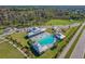 Aerial view of community pool, playground, and parking at 10460 Hawks Landing Dr, Land O Lakes, FL 34638