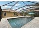 Backyard view of the pool with a screened enclosure and paved deck at 12607 Flatwood Creek Dr, Gibsonton, FL 33534