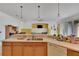 Open kitchen with island, wood cabinets and stainless steel appliances at 12902 Cattail Shore Ln, Riverview, FL 33579