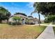 One-story home with three-car garage and landscaping at 12902 Cattail Shore Ln, Riverview, FL 33579