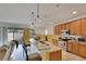 Kitchen features wood cabinets, island, and stainless steel appliances at 12902 Cattail Shore Ln, Riverview, FL 33579