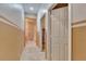 Hallway with carpet, neutral walls, and access to bathroom at 12902 Cattail Shore Ln, Riverview, FL 33579