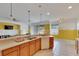 Open kitchen with island, wood cabinets, and stainless steel appliances at 12902 Cattail Shore Ln, Riverview, FL 33579