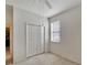 Bright bedroom featuring a window with blinds and double-door closet at 12902 Cattail Shore Ln, Riverview, FL 33579