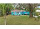 Quaint light blue house on a tree-lined street at 2601 N Wilder Loop, Plant City, FL 33565