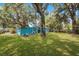 Light blue house with a large backyard and trees at 2601 N Wilder Loop, Plant City, FL 33565