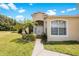 House exterior showcasing a light-colored facade, entryway, and walkway at 30315 Lettingwell Cir, Wesley Chapel, FL 33543