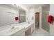 Clean bathroom with double vanity, shower, and plenty of storage at 30315 Lettingwell Cir, Wesley Chapel, FL 33543