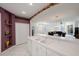 Kitchen with white cabinets, double sinks, and a pass-through to the dining area at 30315 Lettingwell Cir, Wesley Chapel, FL 33543