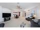 Spacious living room with plush sofas, a large TV, and a ceiling fan at 30315 Lettingwell Cir, Wesley Chapel, FL 33543