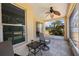 Outdoor screened porch with seating area and ceiling fan at 30315 Lettingwell Cir, Wesley Chapel, FL 33543