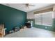 Home office with dark green walls, and window with blinds at 30315 Lettingwell Cir, Wesley Chapel, FL 33543