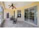 Relaxing screened porch with tiled floor and ceiling fan at 30315 Lettingwell Cir, Wesley Chapel, FL 33543
