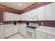 Well-equipped kitchen boasting white cabinets and black appliances at 30315 Lettingwell Cir, Wesley Chapel, FL 33543