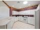 Modern kitchen with white cabinets, stainless steel appliances and a view to the dining area at 30315 Lettingwell Cir, Wesley Chapel, FL 33543